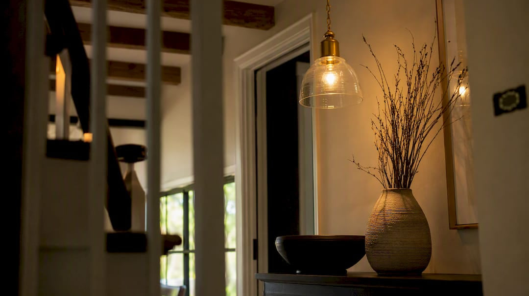 Warmly lit residential entryway with pendant light