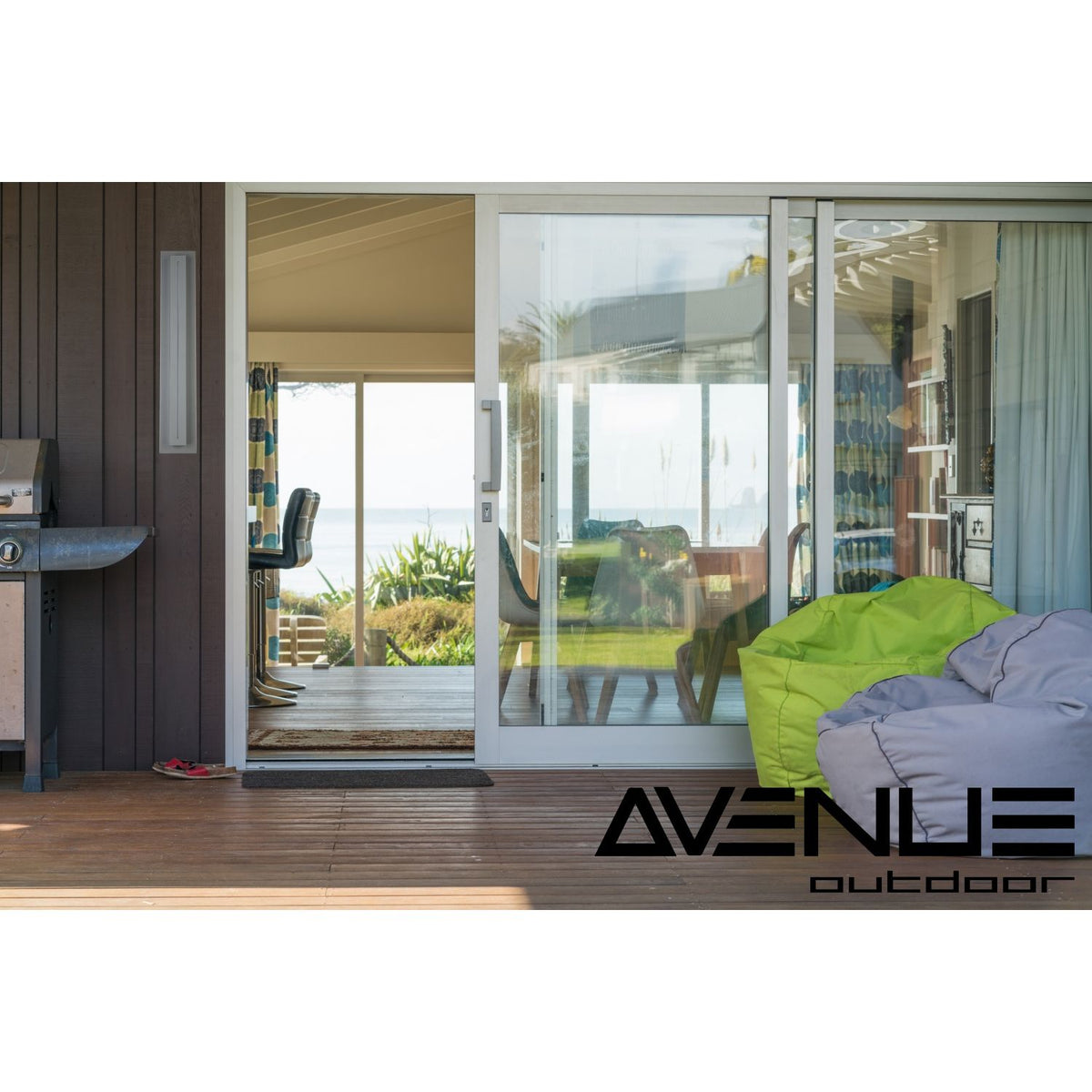 Avenue Outdoor Raised Panel LED Wall Sconce AV3228-SLV installed on modern exterior — raised panel glowing with warm white LED, silver finish