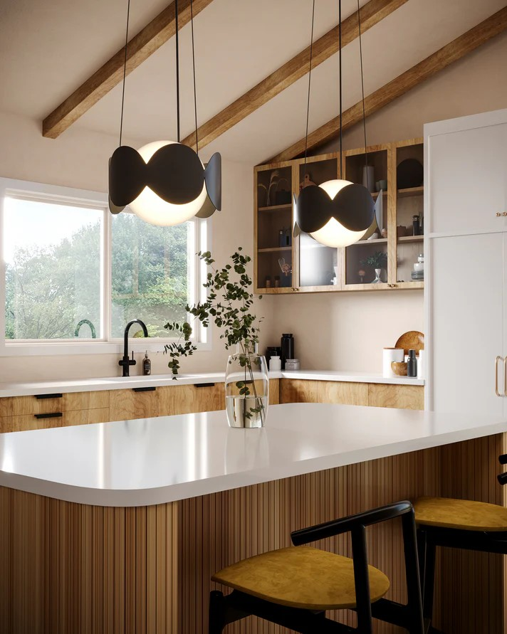 Modern kitchen with white countertops, wooden cabinets, and Kuzco Lighting pendant lights.