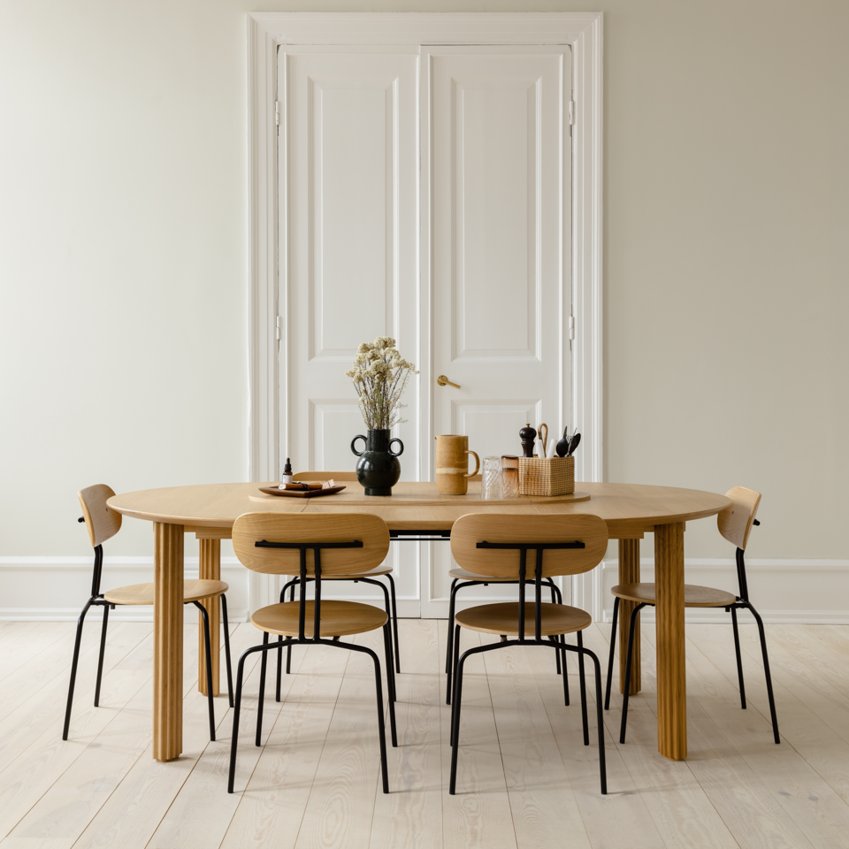 Umage Comfort Circle Dining Table with extension styled in a room setting