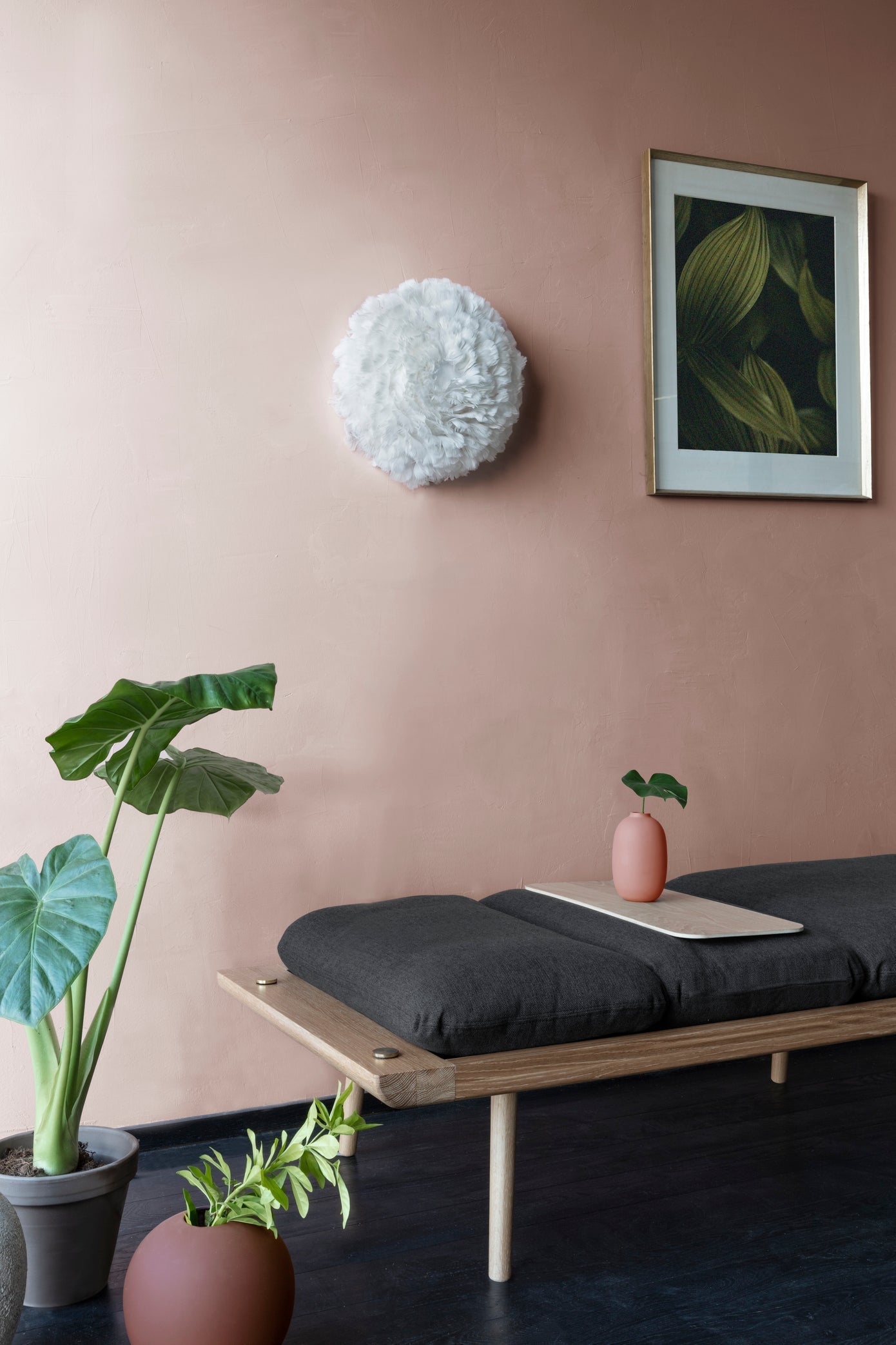 Umage Eos Up Ceiling or Wall Light above an oak daybed