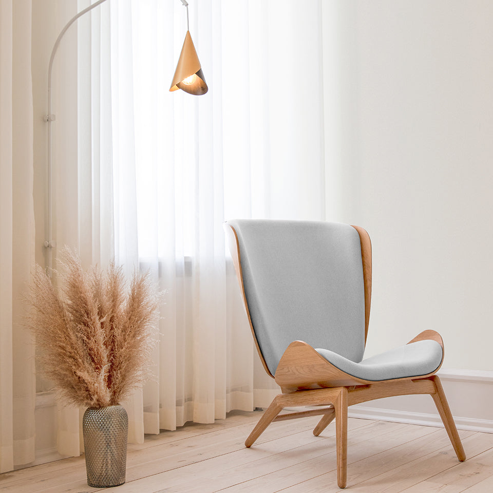 Umage The Reader Wing Chair in oak with Sterling, styled in a living room