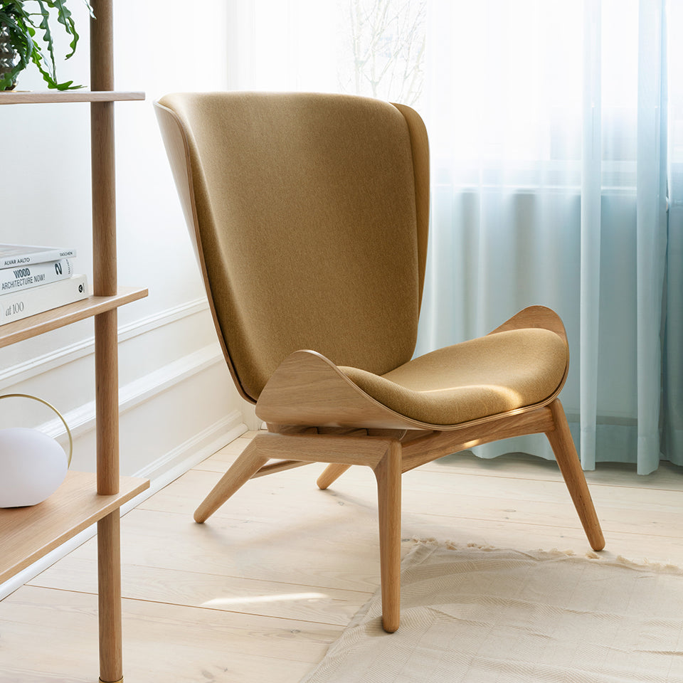 Umage The Reader Wing Chair in oak with Sugar Brown, styled with Stories and Orbit