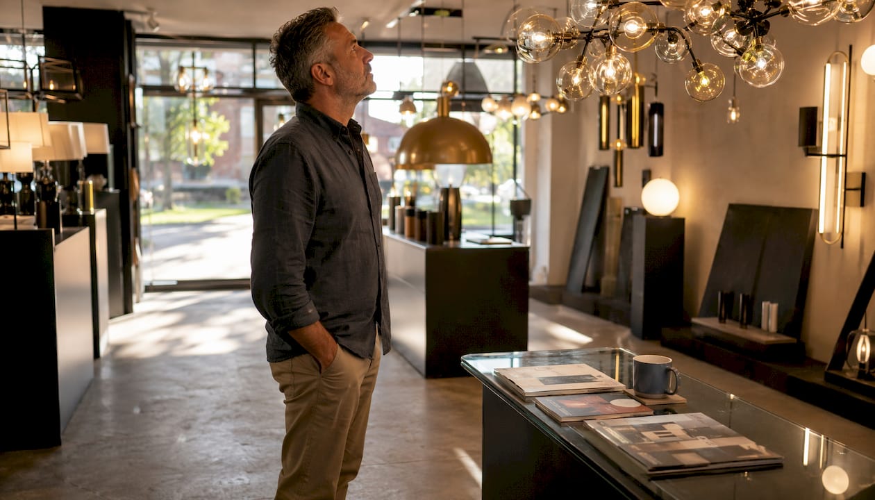 Homeowner browsing lighting store showroom