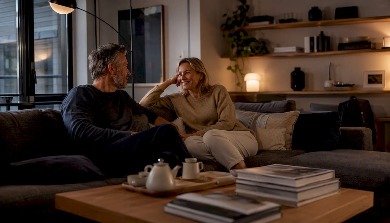 Couple enjoying warm white lit living room