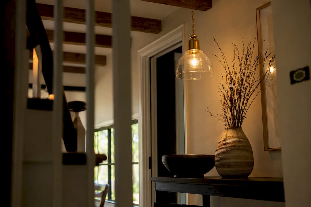 Warmly lit residential entryway with pendant light