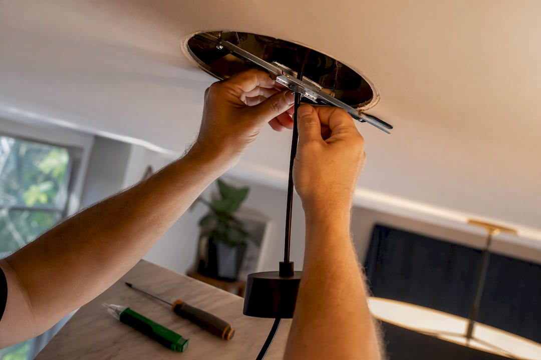 Hands fitting a pendant conversion brace