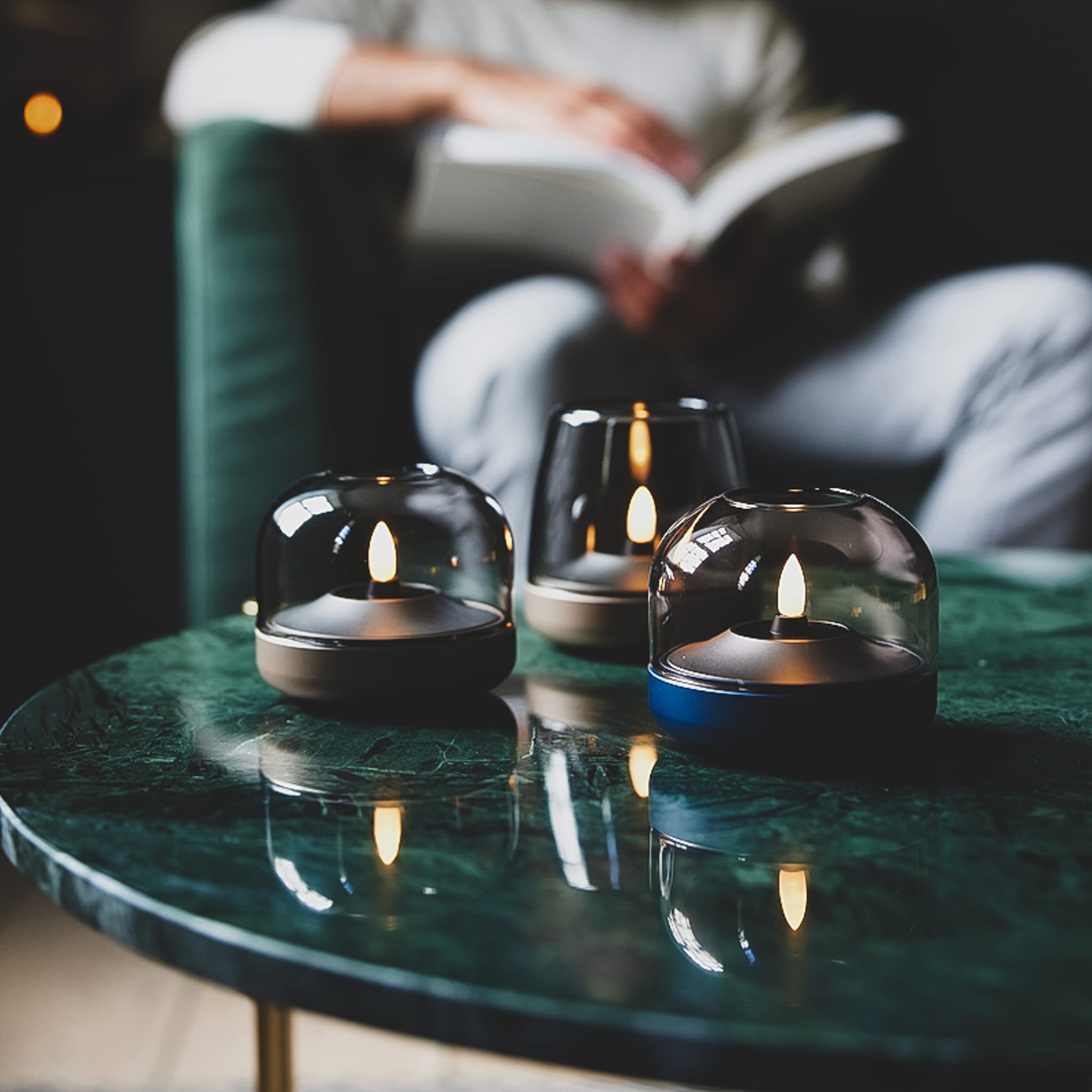 Glow 08 glass-dome candle holders compatible with Shine LED candle on a green marble table.