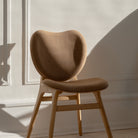 Umage A Conversation Piece dining chair styled in a room setting