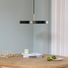 Umage Asteria LED Pendant in Black over a dining table
