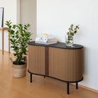 Umage Audacious Cabinet in black oak with Sugar Brown doors, styled in a living room