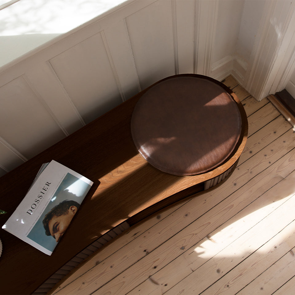 Umage Audacious TV Bench in dark oak with Hazelnut doors, styled in a living room