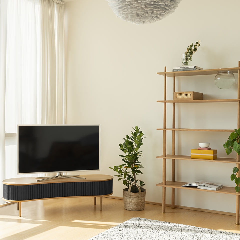 Umage Audacious TV Bench in oak with Charcoal doors, styled in a living room