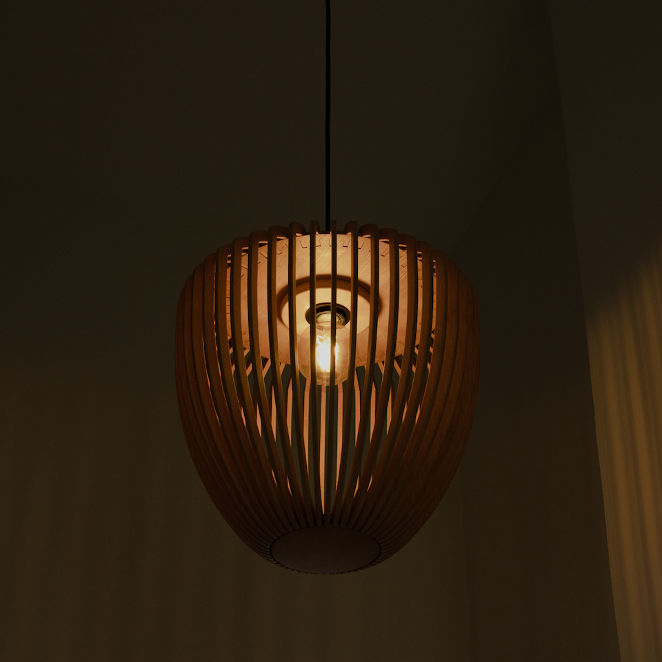 Umage Clava Wood Tripod Floor Lamp styled in a room setting