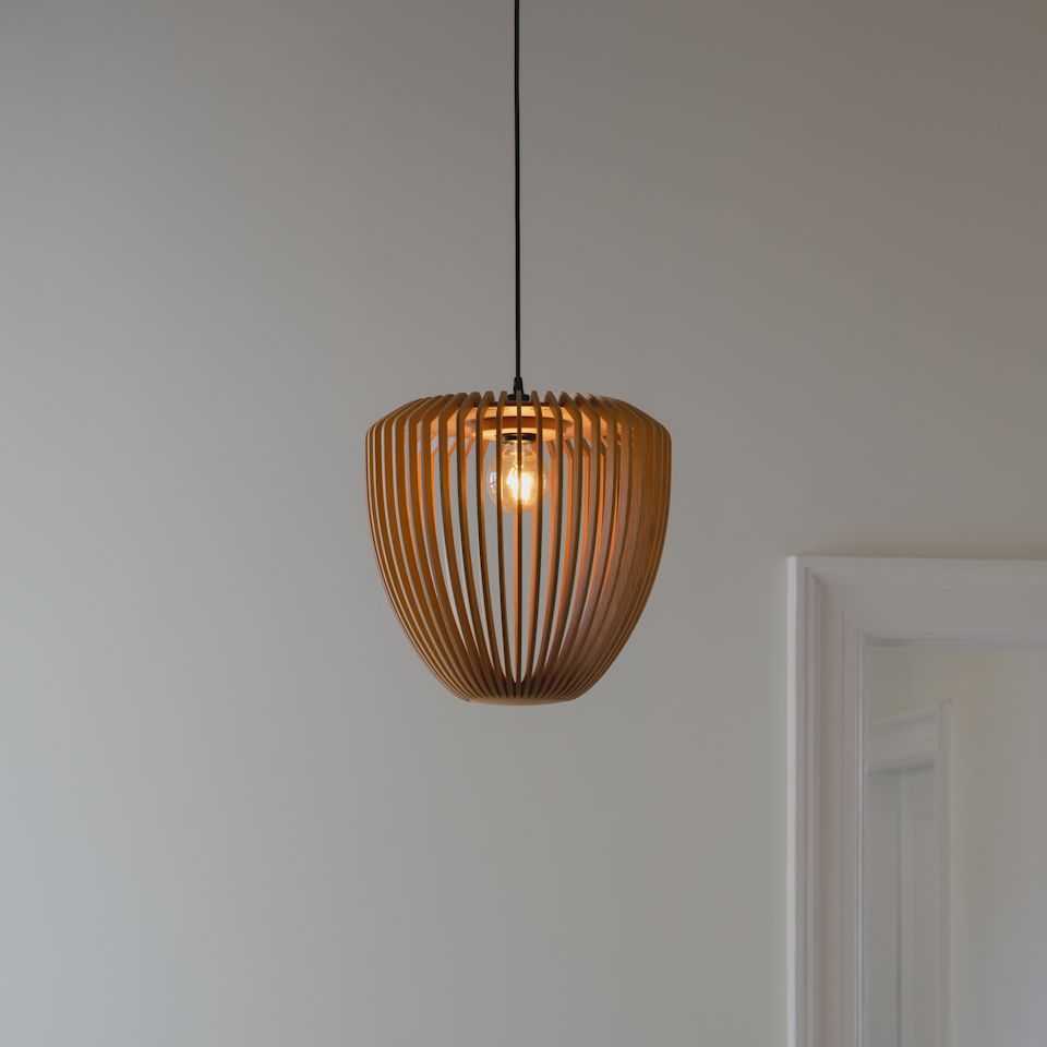 Umage Clava Wood Tripod Base Floor Lamp styled in a room setting