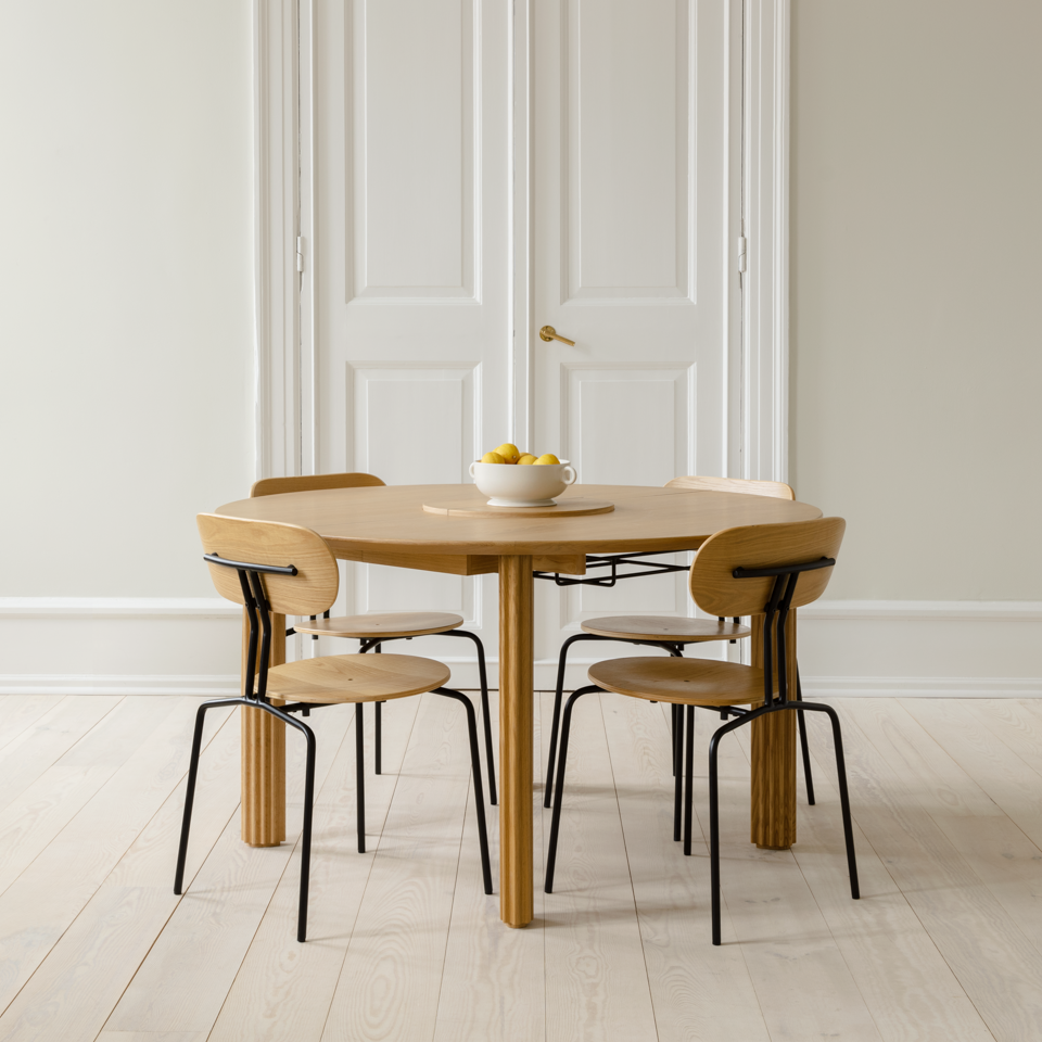 Umage Comfort Circle Dining Table with extension styled in a room setting