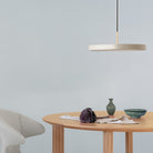 Umage Asteria LED Pendant in Pearl White above an oak dining table
