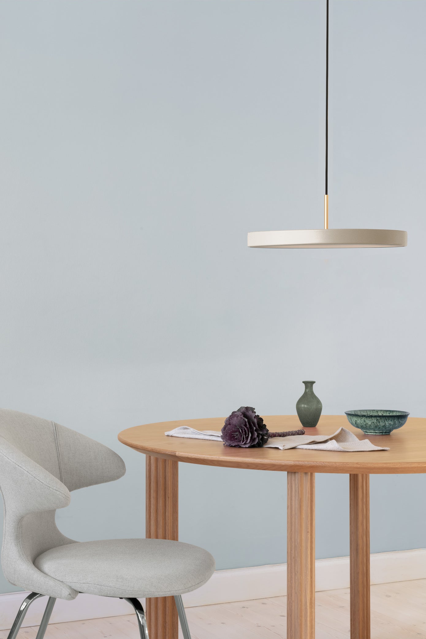 Umage Asteria LED Pendant in Pearl White above a round dining table