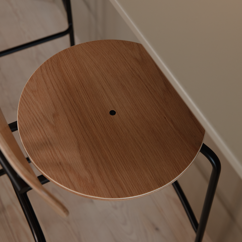 Umage Curious Bar Stool in oak with black legs, styled in a kitchen