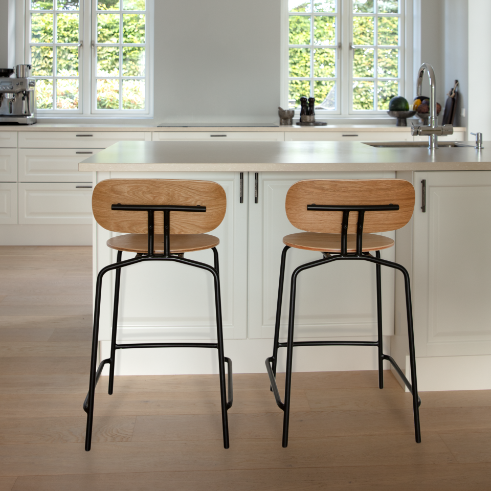Umage Curious Counter Stool in oak with black legs, styled at a kitchen counter