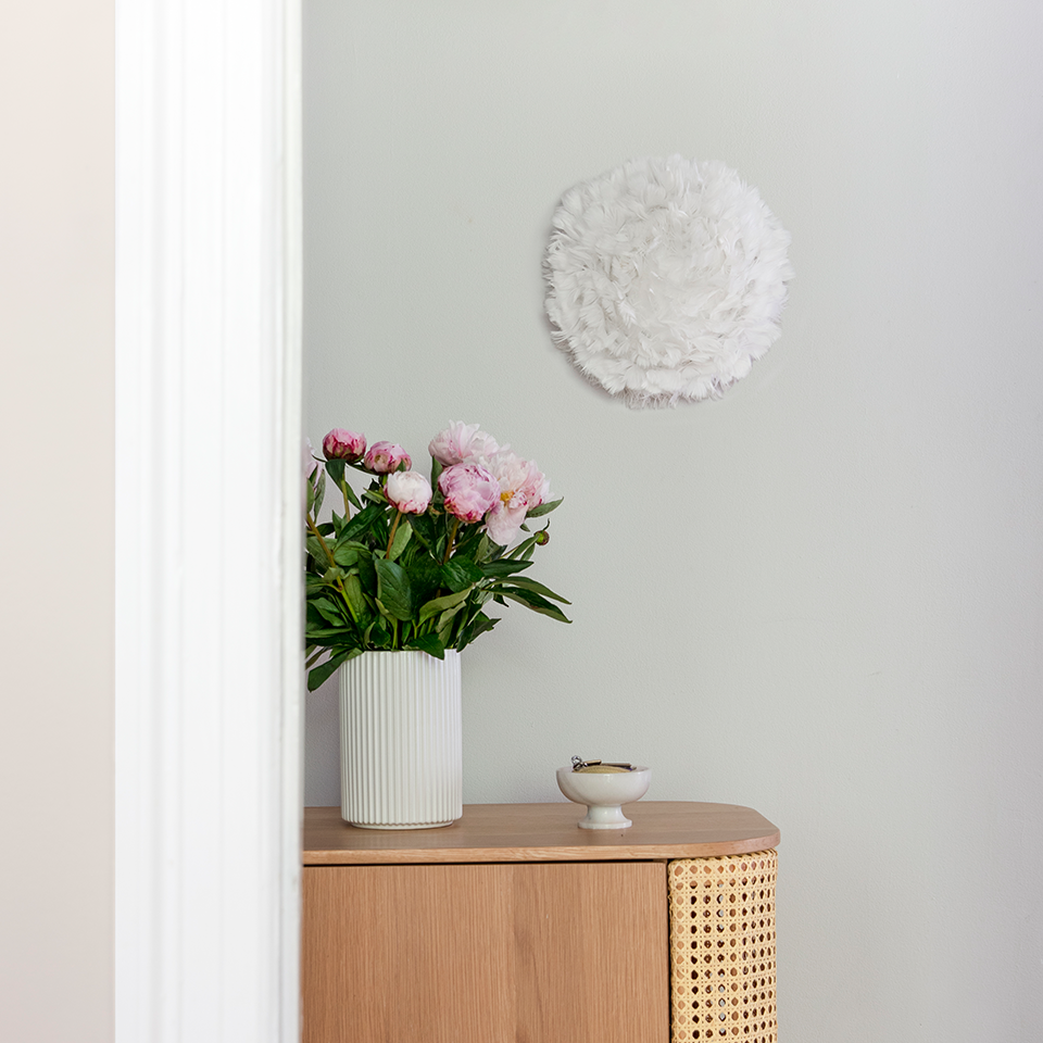 Umage Eos Up Ceiling or Wall Light mounted above an oak cabinet