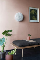 Umage Eos Up Ceiling or Wall Light above an oak daybed