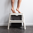 Umage Step It Up Step Stool in Pearl White, styled in an entryway