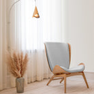 Umage The Reader Wing Chair in oak with Sterling, styled in a living room