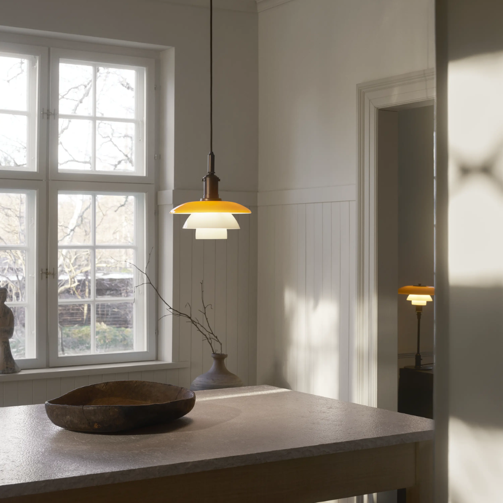 Louis Poulsen 5741938685 PH 3/3 Pendant Centenary Edition lifestyle over dining table in Amber / Opal White